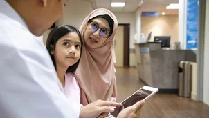 Parent and a child talking to a doctor