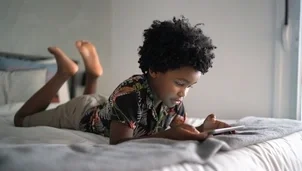 Child lying on a bed