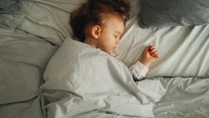 Child sleeping in a bed