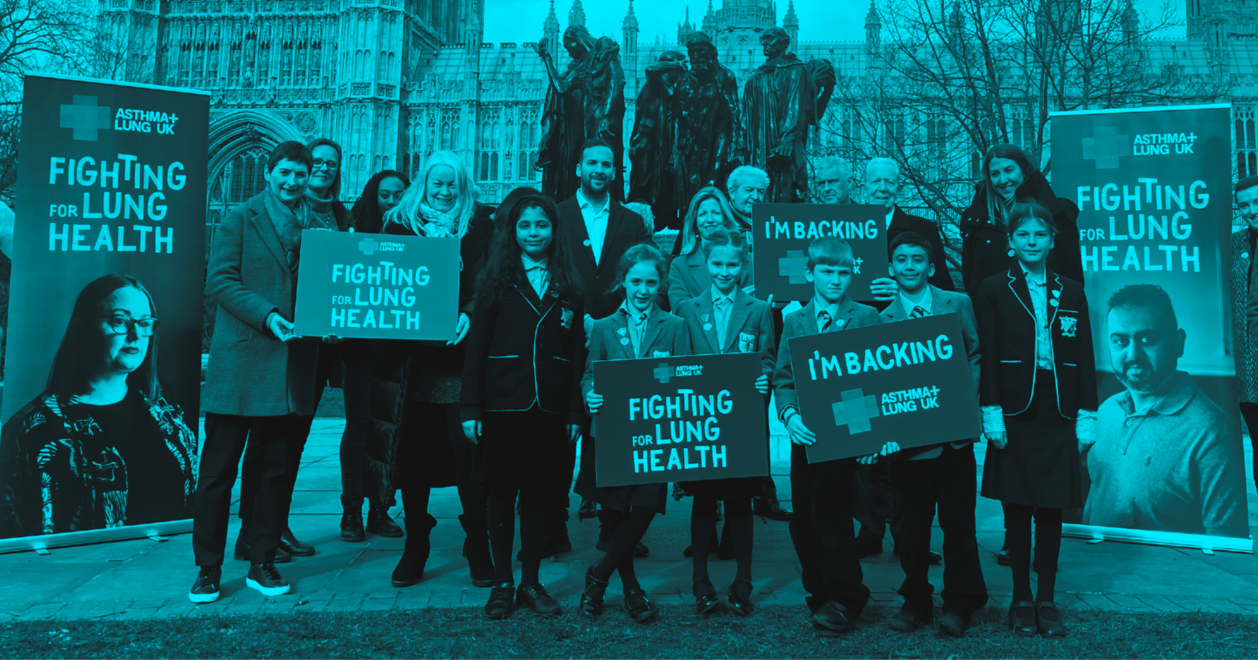 Group of people standing outside the Houses of Parliament campaigning