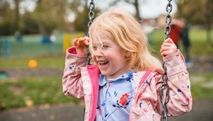 Smiling child on a swing