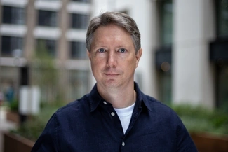 Image of man in front of building