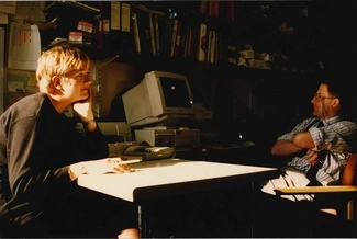 A woman and a man working at their desk